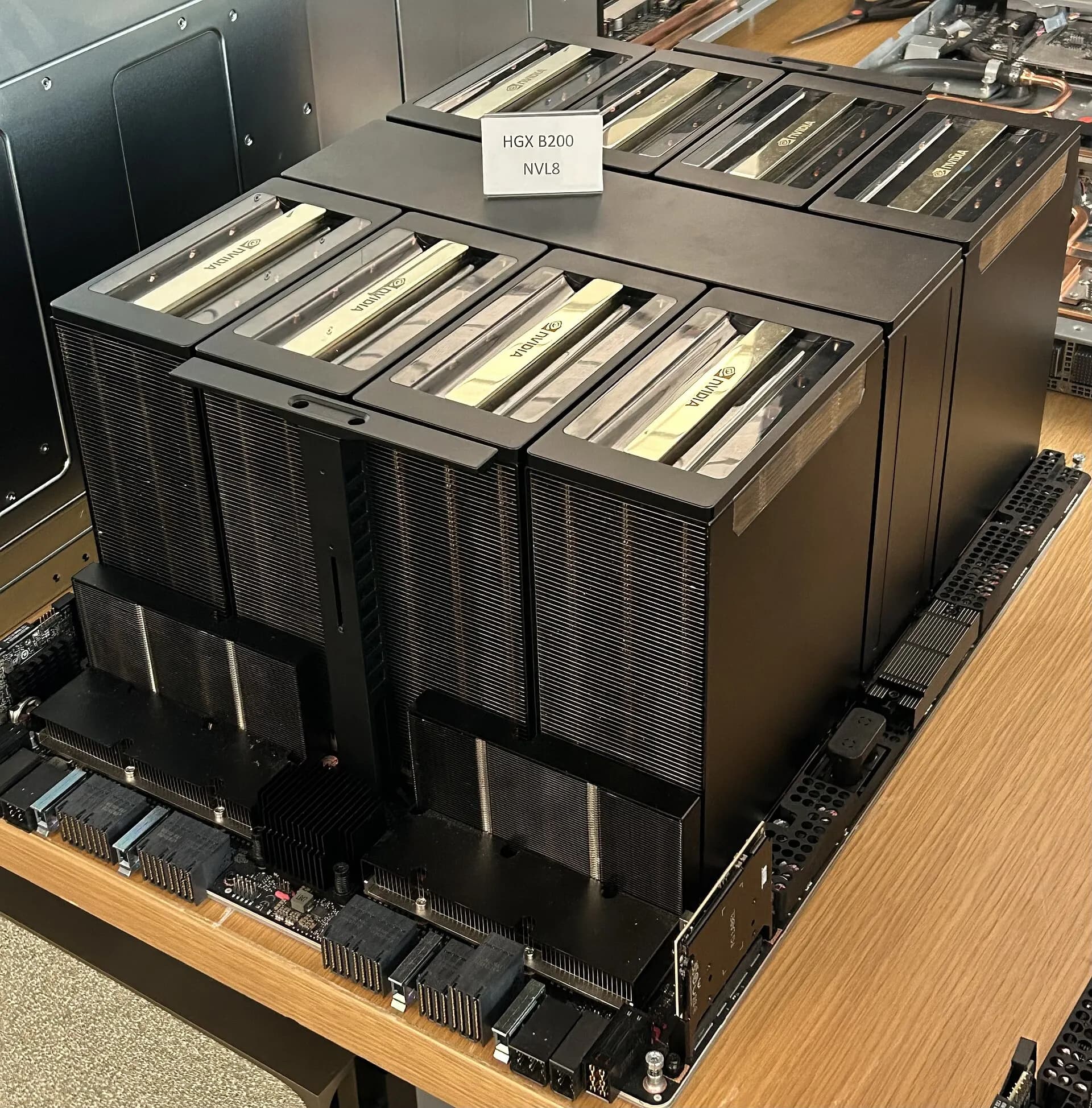 An NVIDIA HGX B200 board with eight GPU heatsinks on a server tray